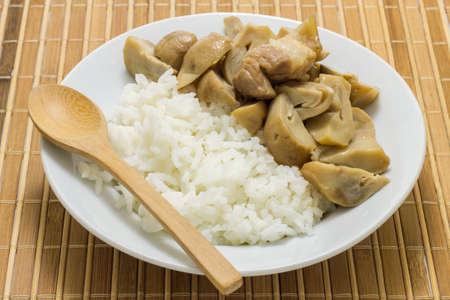 Stir fried mushrooms with pork on wooden background,Thai food.の写真素材