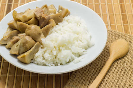 Stir fried mushrooms with pork on wooden background,Thai food.の写真素材