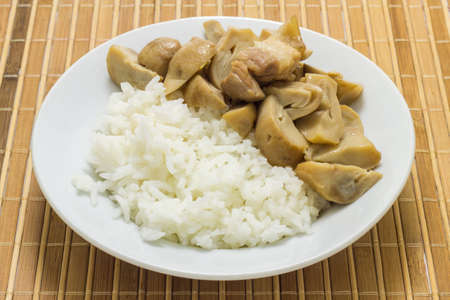 Stir fried mushrooms with pork on wooden background,Thai food.の写真素材