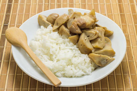 Stir fried mushrooms with pork on wooden background,Thai food.の写真素材