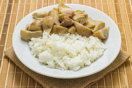 Stir fried mushrooms with pork on wooden background,Thai food.の写真素材