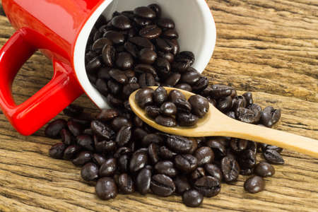 Coffee beans with in coffee cup on wooden background.の写真素材