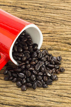 Coffee beans with in coffee cup on wooden background.の写真素材