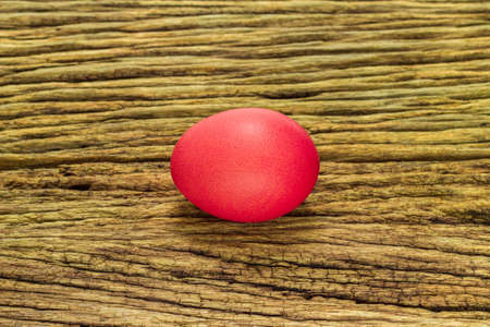 Red ester egg on a wooden bacground.