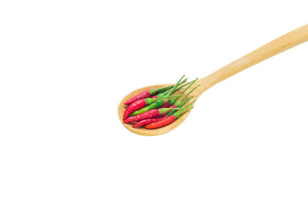 Red chili pepper in wooden spoon isolated on white background.の写真素材
