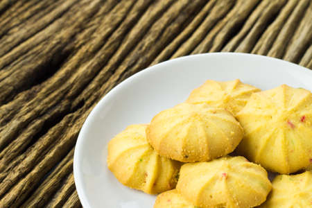 Cookies in a dish on the wooden teble.の写真素材