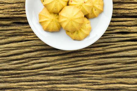 Cookies in a dish on the wooden teble.の写真素材