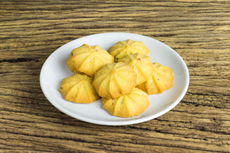 Cookies in a dish on the wooden teble.の写真素材