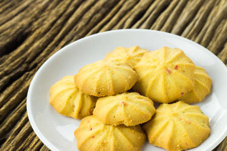 Cookies in a dish on the wooden teble.の写真素材