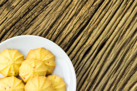 Cookies in a dish on the wooden teble.の写真素材