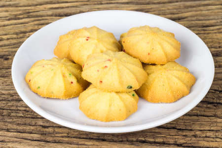 Cookies in a dish on the wooden teble.の写真素材