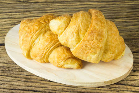 Tasty croissants on brown wooden background.の写真素材