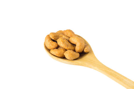 Roasted Cashew Nuts on wooden spoon isolated on white background.の写真素材