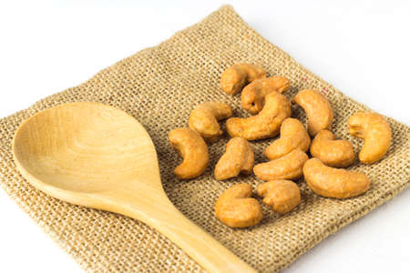 Cashew salted nuts and spoon on white background.の写真素材