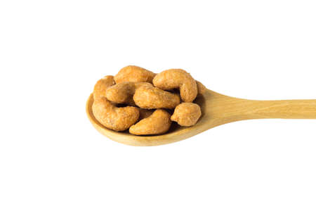 Roasted Cashew Nuts on wooden spoon isolated on white background.の写真素材