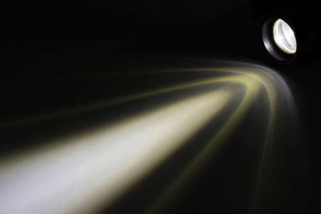 LED flashlight with a light beam at night.の写真素材