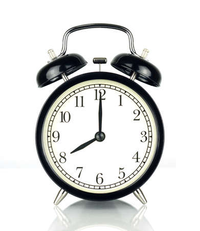 Alarm Clock isolated on white, in black and white, showing eight o'clock.の写真素材