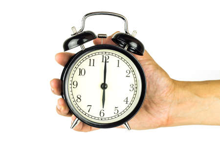 Hand holding a clock, on a white background.の写真素材