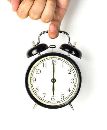 Hand holding a clock, on a white background.の写真素材