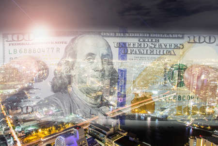 Double exposure of money with cityscape blurred building background. の写真素材