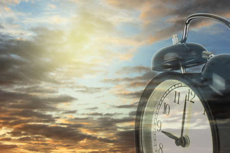 Double exposure of clock with sky background.の写真素材