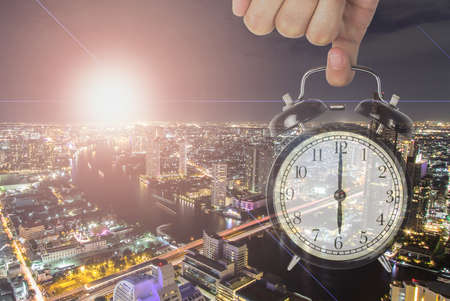Double exposure of clock with cityscape building background.の写真素材