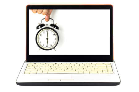 Alarm clock and laptop.の写真素材