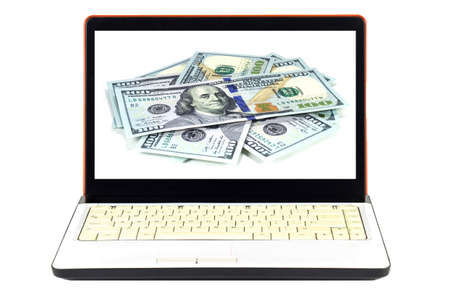 Laptop full of dollars.の写真素材