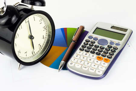 Analyzing graphics, calculations, savings with alarm clock.の写真素材