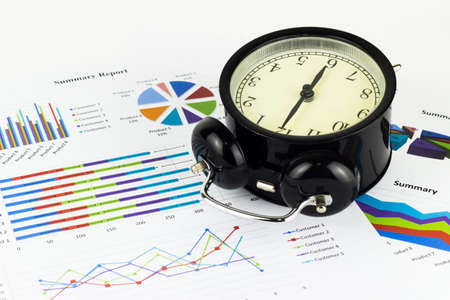Analyzing graphics, calculations, savings with alarm clock.の写真素材