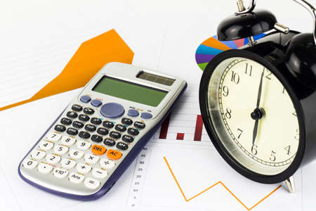 Analyzing graphics, calculations, savings with alarm clock.の写真素材