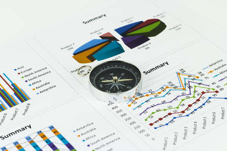 Bussiness graphs and finances with a compass lying nearby.の写真素材