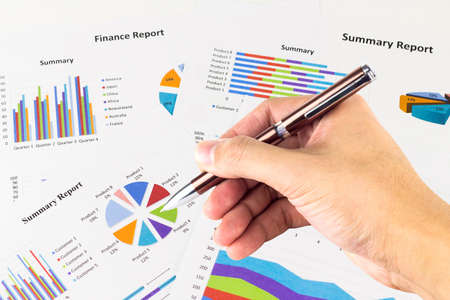 Pen in the man's hand, calculations,finances and analysis of the market concept.