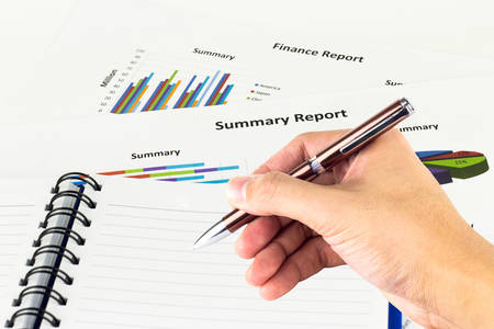 Pen in the man's hand, calculations,finances and analysis of the market concept.の写真素材