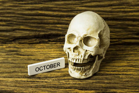 Skull and October label on wooden backgroundの写真素材