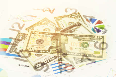 Double exposure of Business graph, money and clock for finance and banking concept.の写真素材