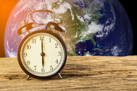 Clock with a view of the earth background, Elements of this image furnished by NASA.の写真素材