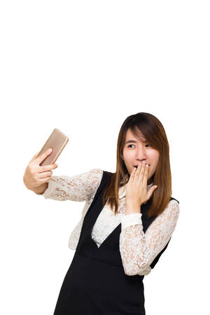 Young Asian woman making selfie photo on smartphone isolated on a white background,の写真素材