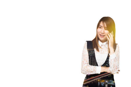 Young Asian Business woman smile talking on the mobile phone and building image double exposure.の写真素材