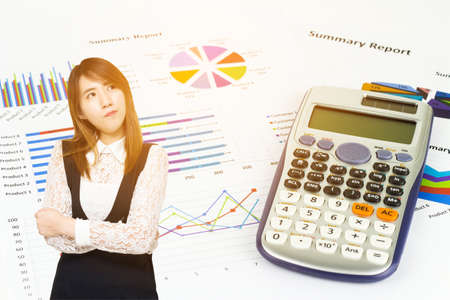 Young Asian business woman thinking with calculations, savings, finances and economy concept.の写真素材