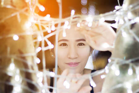 Close up young cute and beautiful asian girl with bokeh light on background.の写真素材