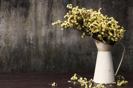 Vase with withered flowers on the old wooden / Still life image and Select focus.の写真素材