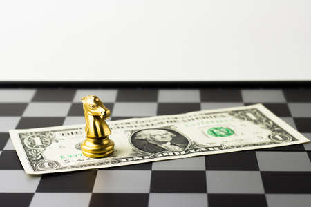 Golden Knight chess and dollar money.の写真素材