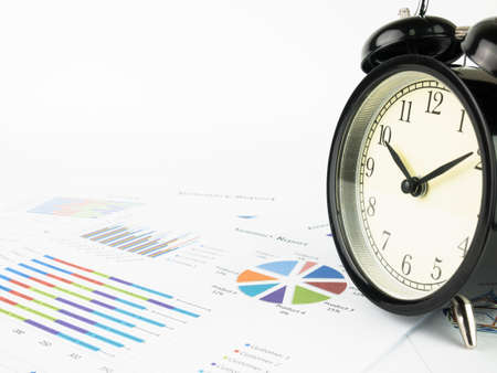Business document. Financial data and Alarm clock on white background.の写真素材