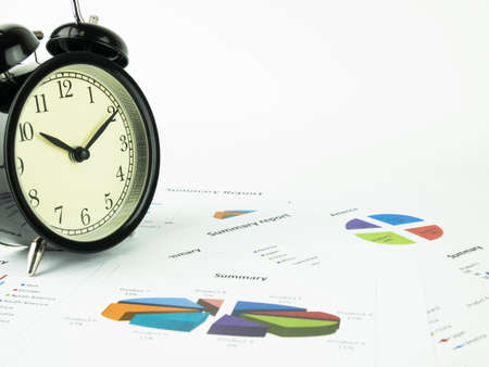 Business document. Financial data and Alarm clock on white background.の写真素材
