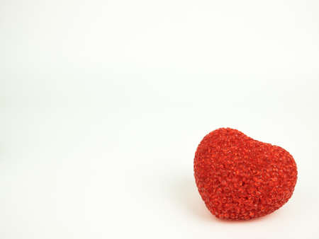 A red heart on white background for Valentines, postcards and design.の写真素材