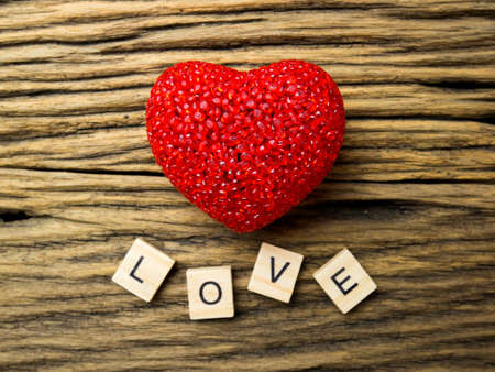 Top view of Red heart on wooden blackground, LOVE word in wooden cube, Valentine's Day.の写真素材