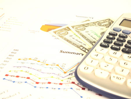 Business chart near dollars by calculator, Financial concept.の写真素材