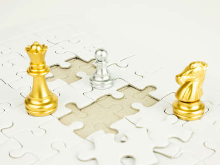 Gold and Silver chess piece on jigsaw puzzle background, business concept.の写真素材