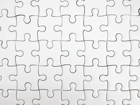 White jigsaw puzzle pieces completed as copy space.の写真素材